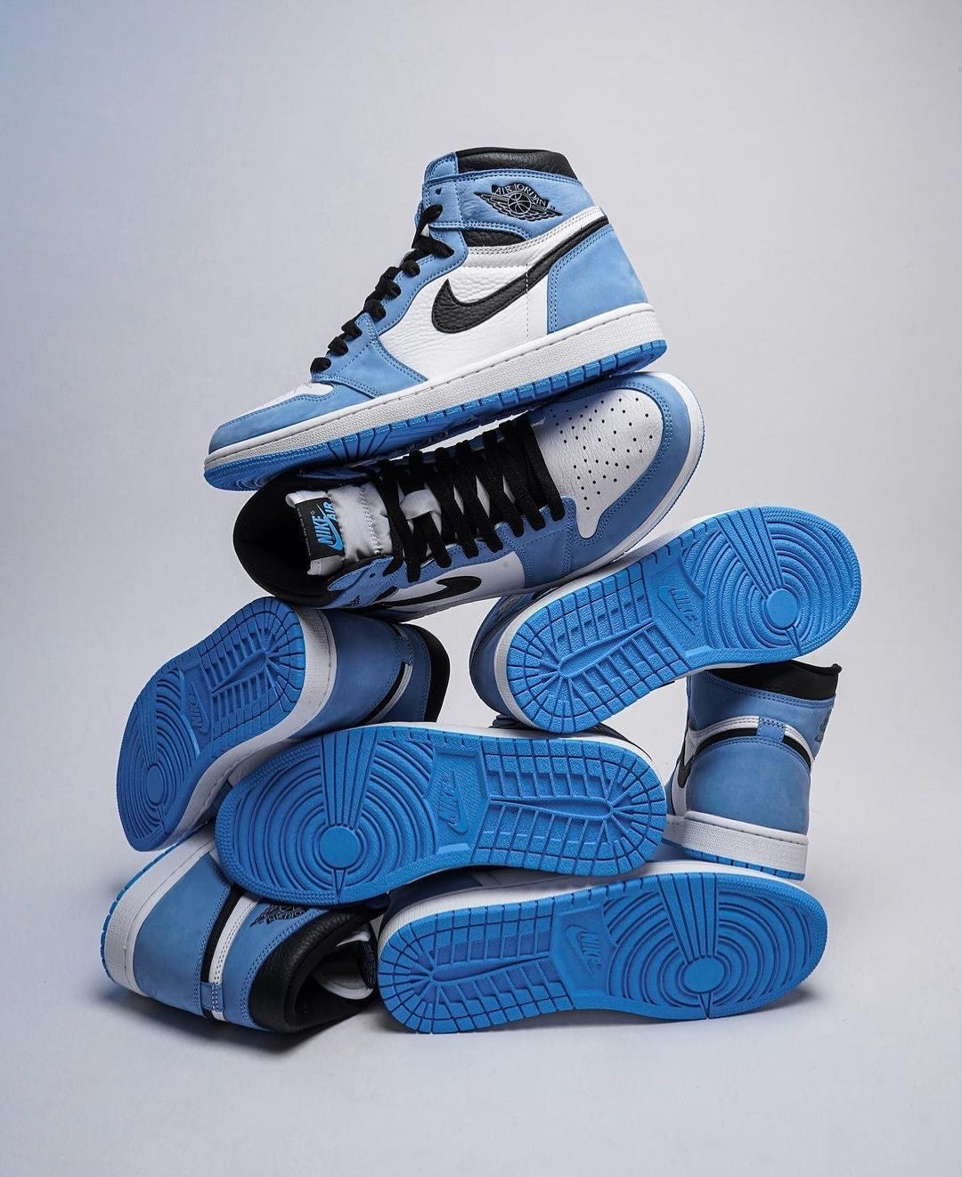a pair of blue and white sneakers stacked on top of each other
