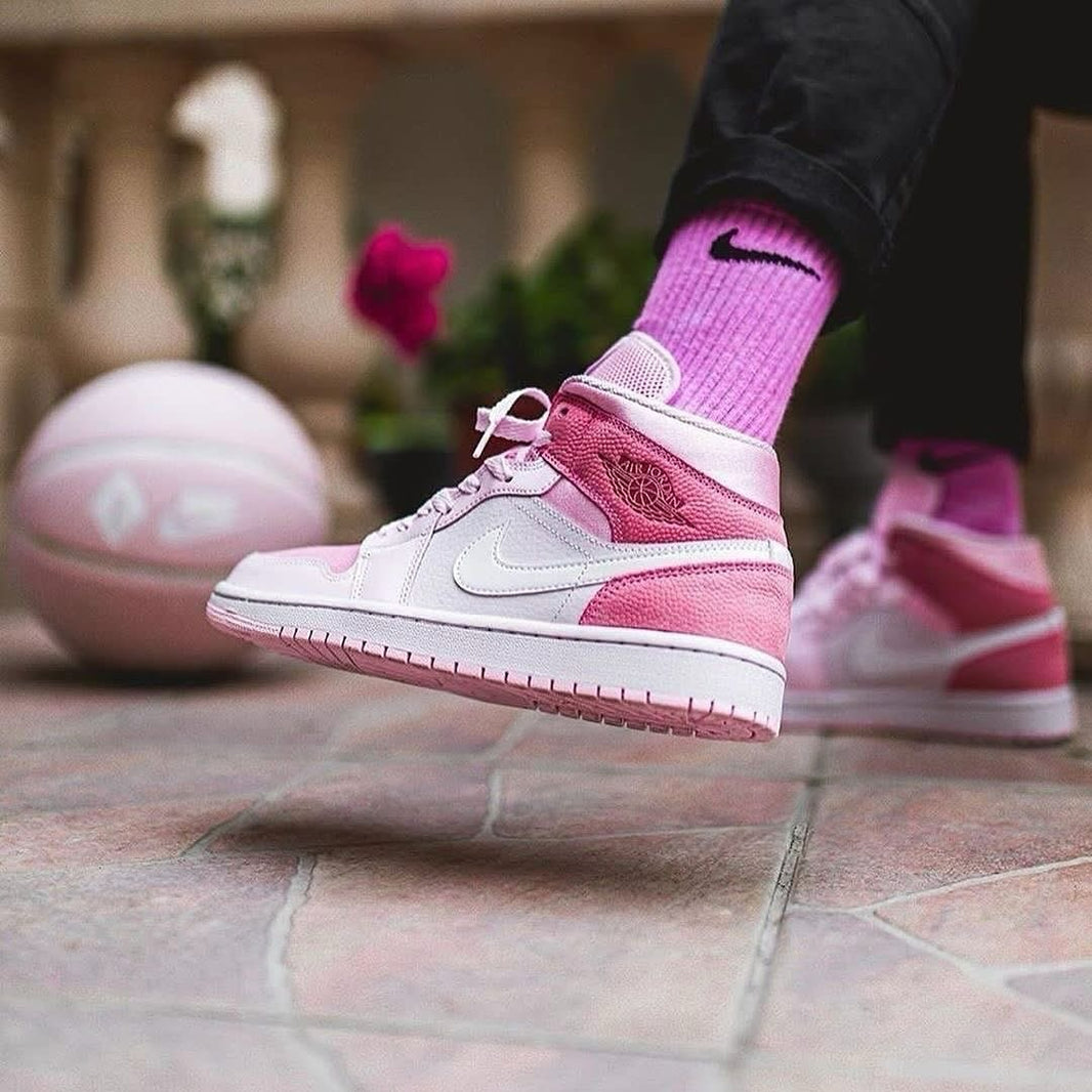 a person wearing pink and white shoes and socks